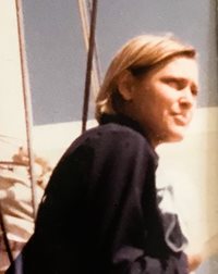 Kristin Caperton, a founder of the United States Academic Decathlon (USAD), in an outdoor setting.